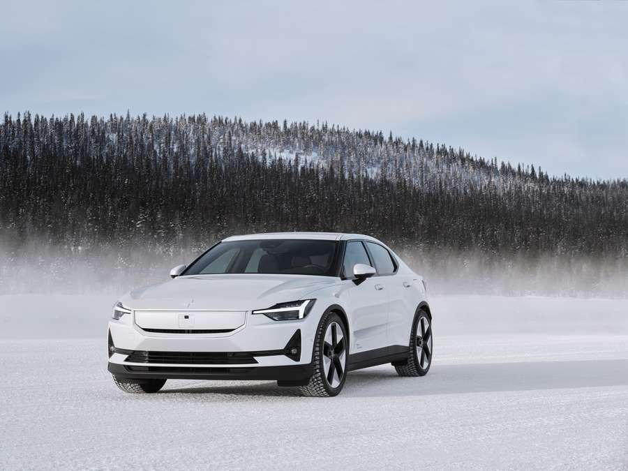 a white polestar 2 driving in the snow