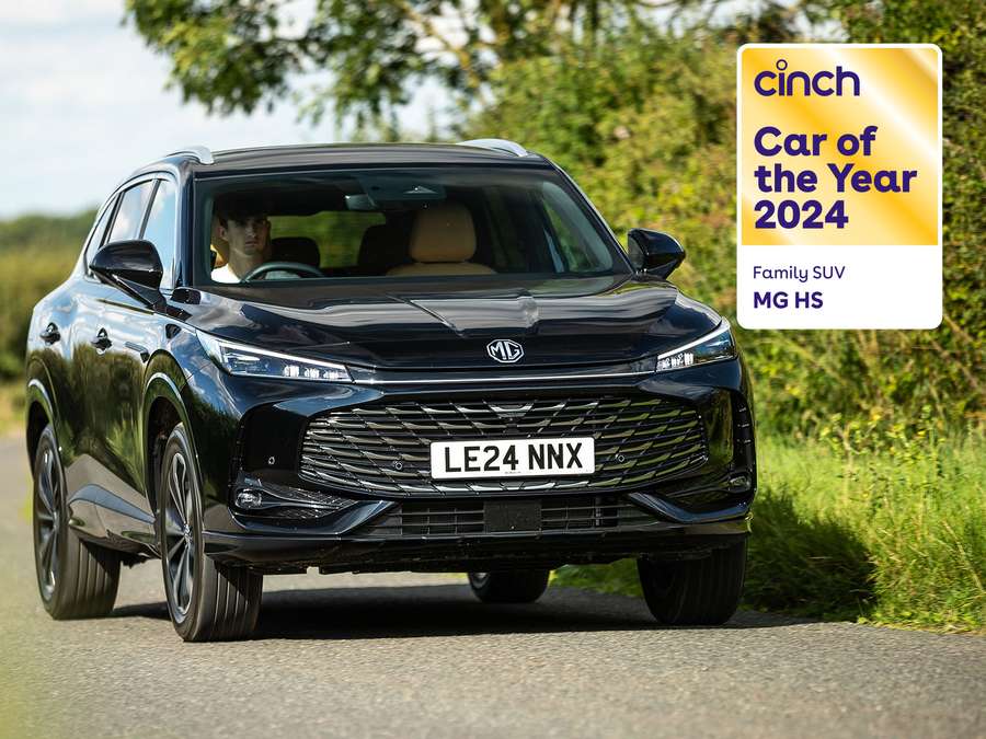 a black MG HS driving on a country road