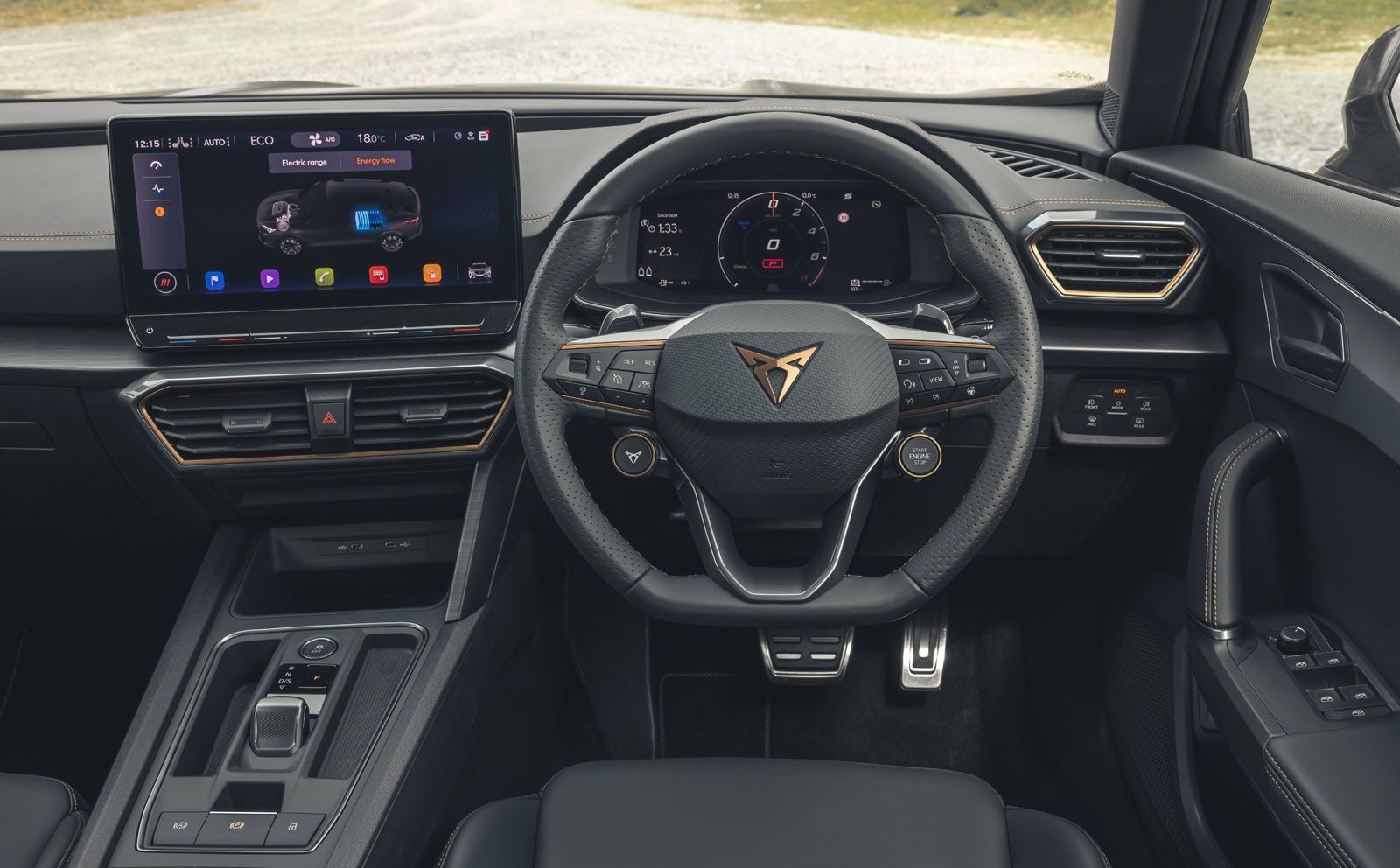 Modern car interior with a digital dashboard, sleek steering wheel, and large central touchscreen displaying multimedia and navigation controls.