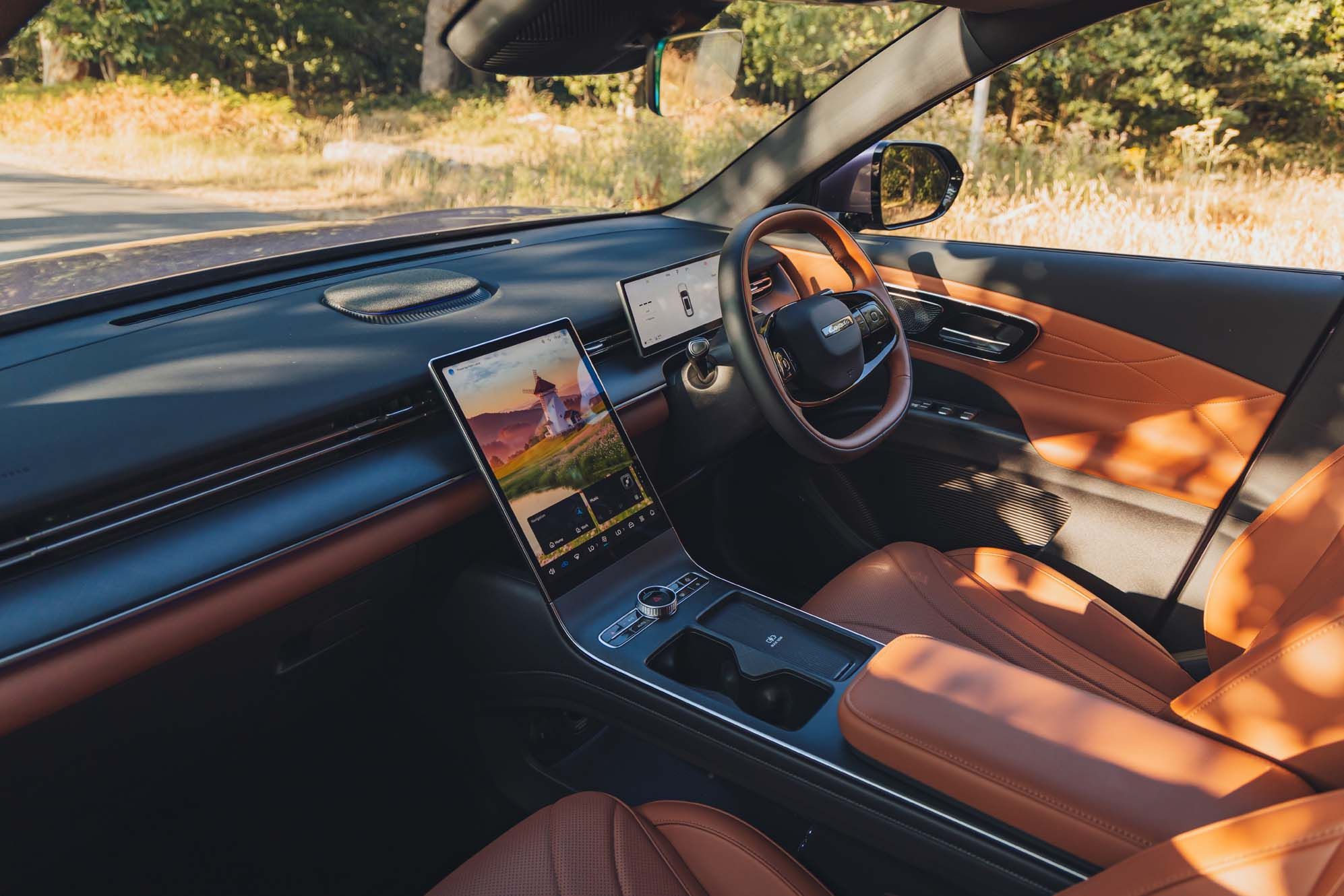 LEPAS L8 interior with brown leather seats, a digital dashboard, and a large central touchscreen display. Sunlight filters through the windows.