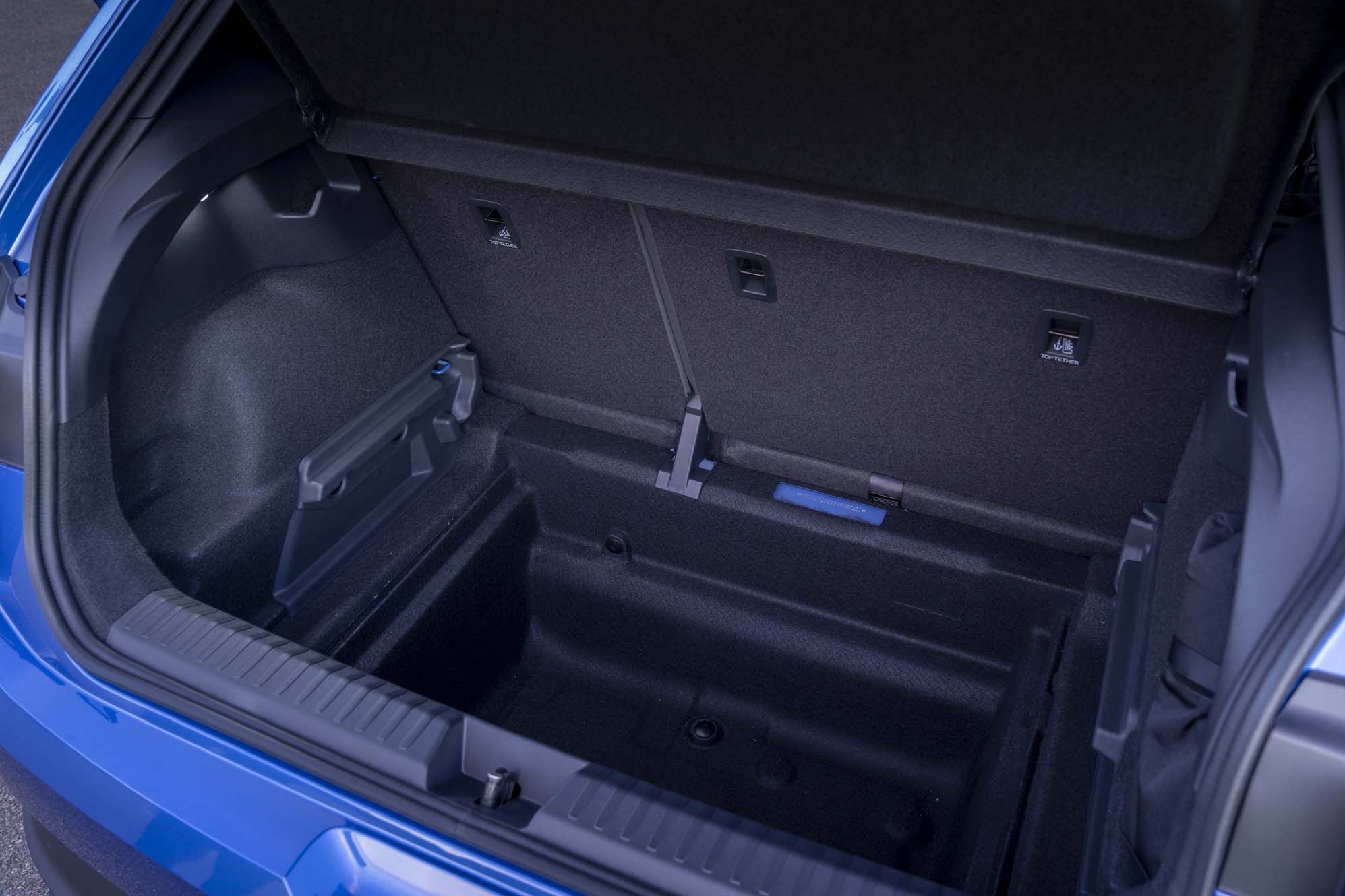 An empty blue VW ID. Polo boot with a top tether latch and storage compartment.
