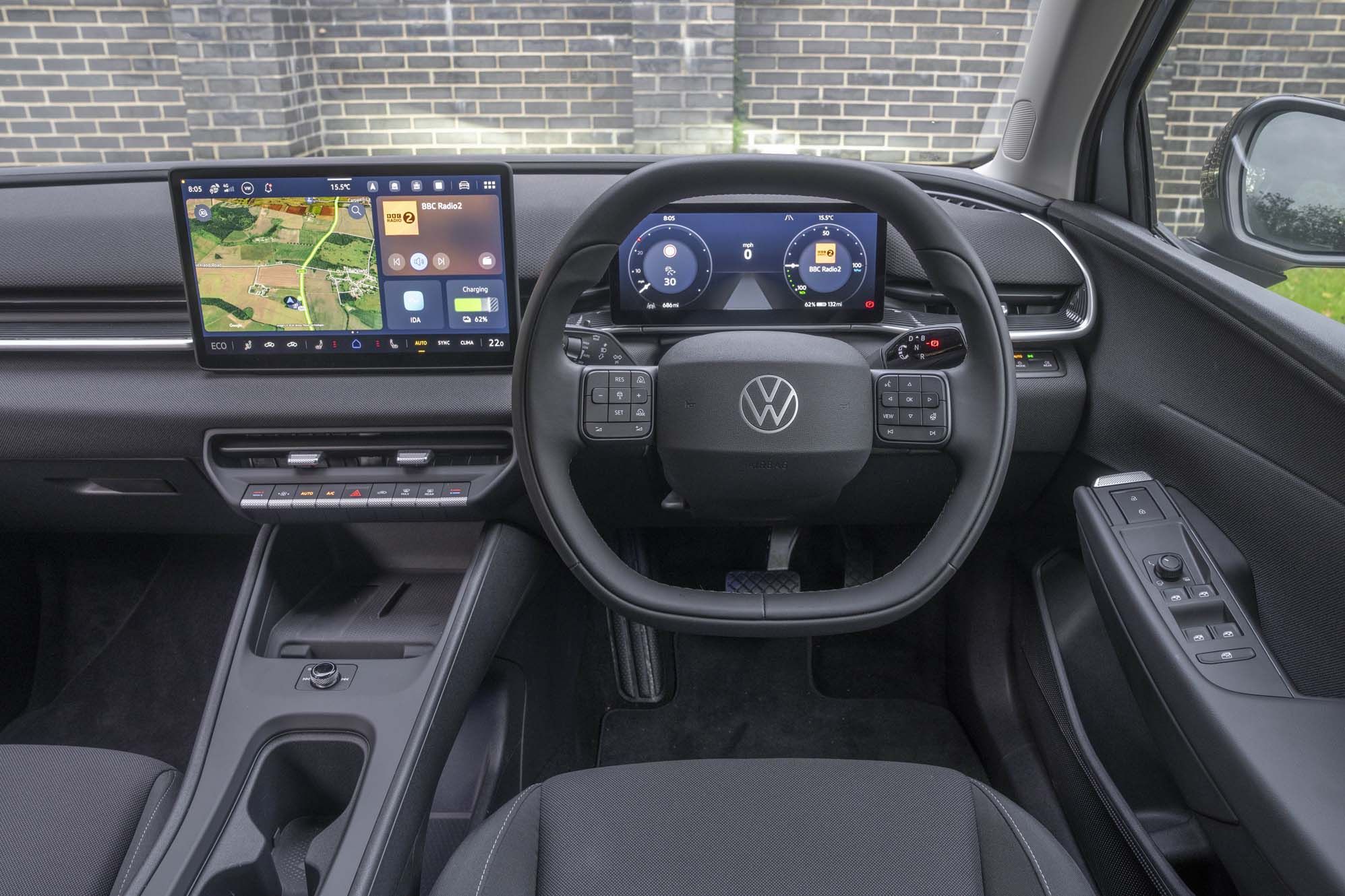 Interior of a VW ID. Polo showing the steering wheel with controls, dashboard digital displays, and a central touchscreen with navigation.