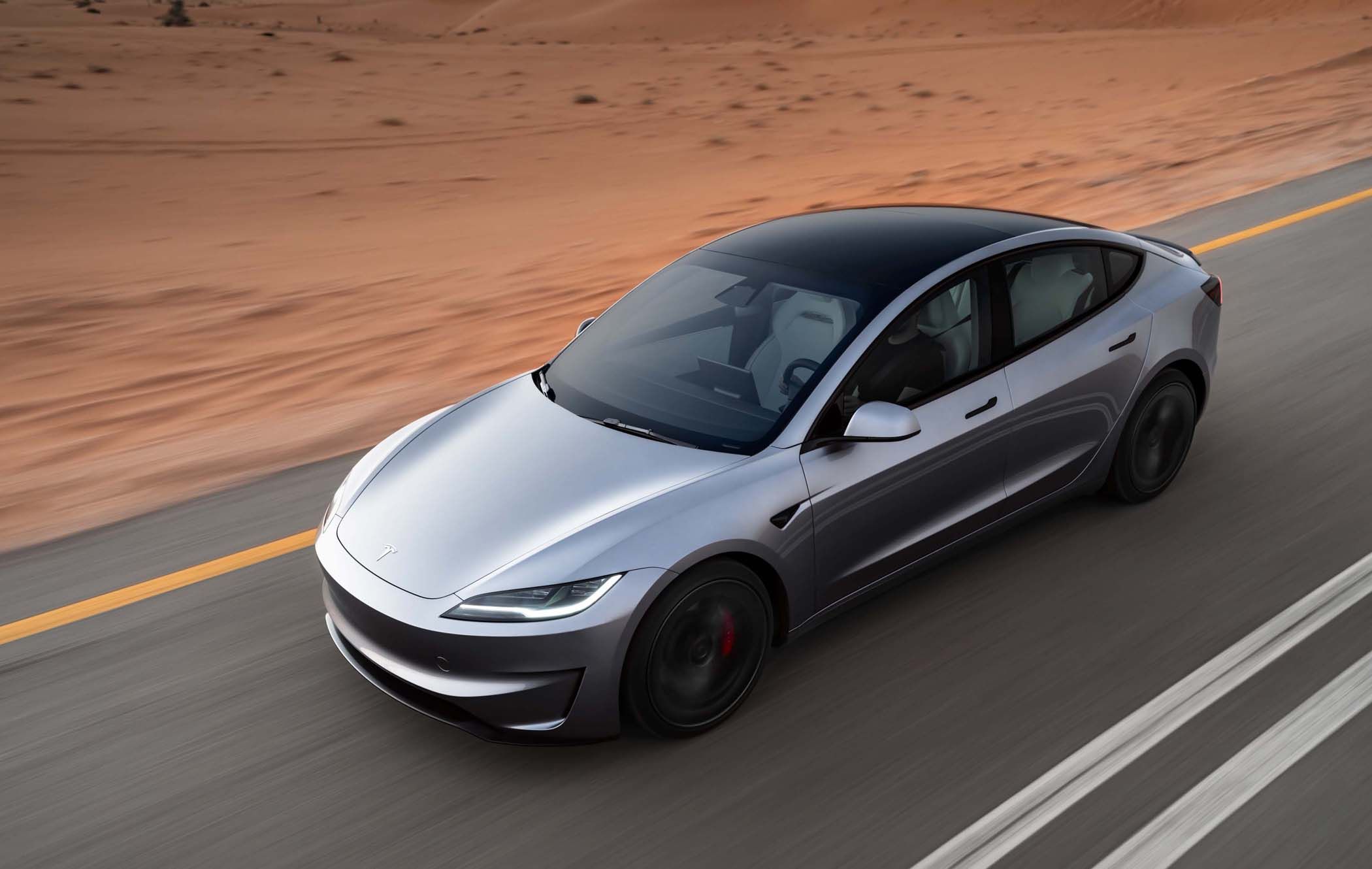 Tesla Model 3 Highland front three quarters, driving