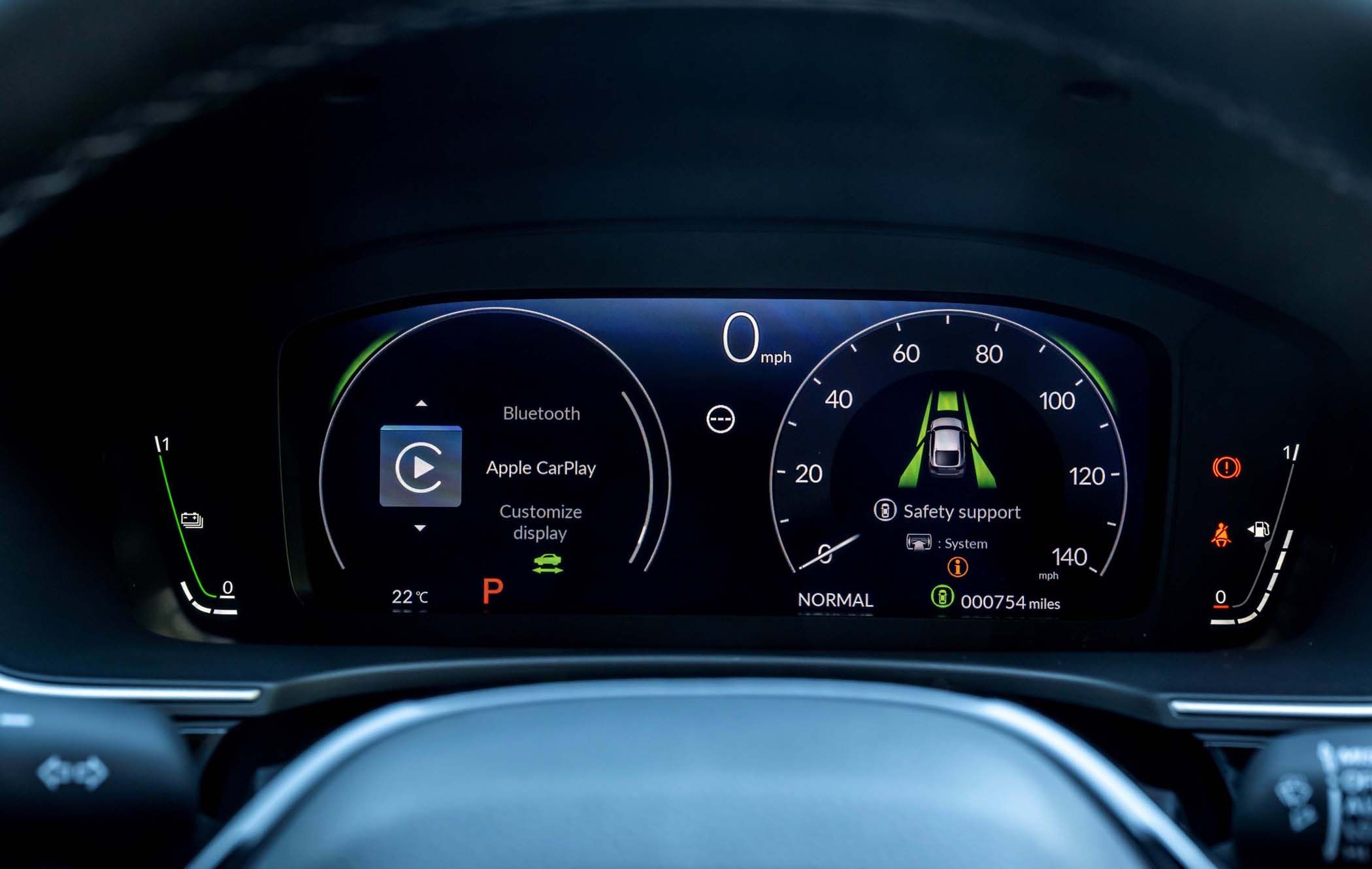 Close-up of a Honda Civic's digital dashboard displaying speedometer, Bluetooth, Apple CarPlay, temperature, and mileage indicators.