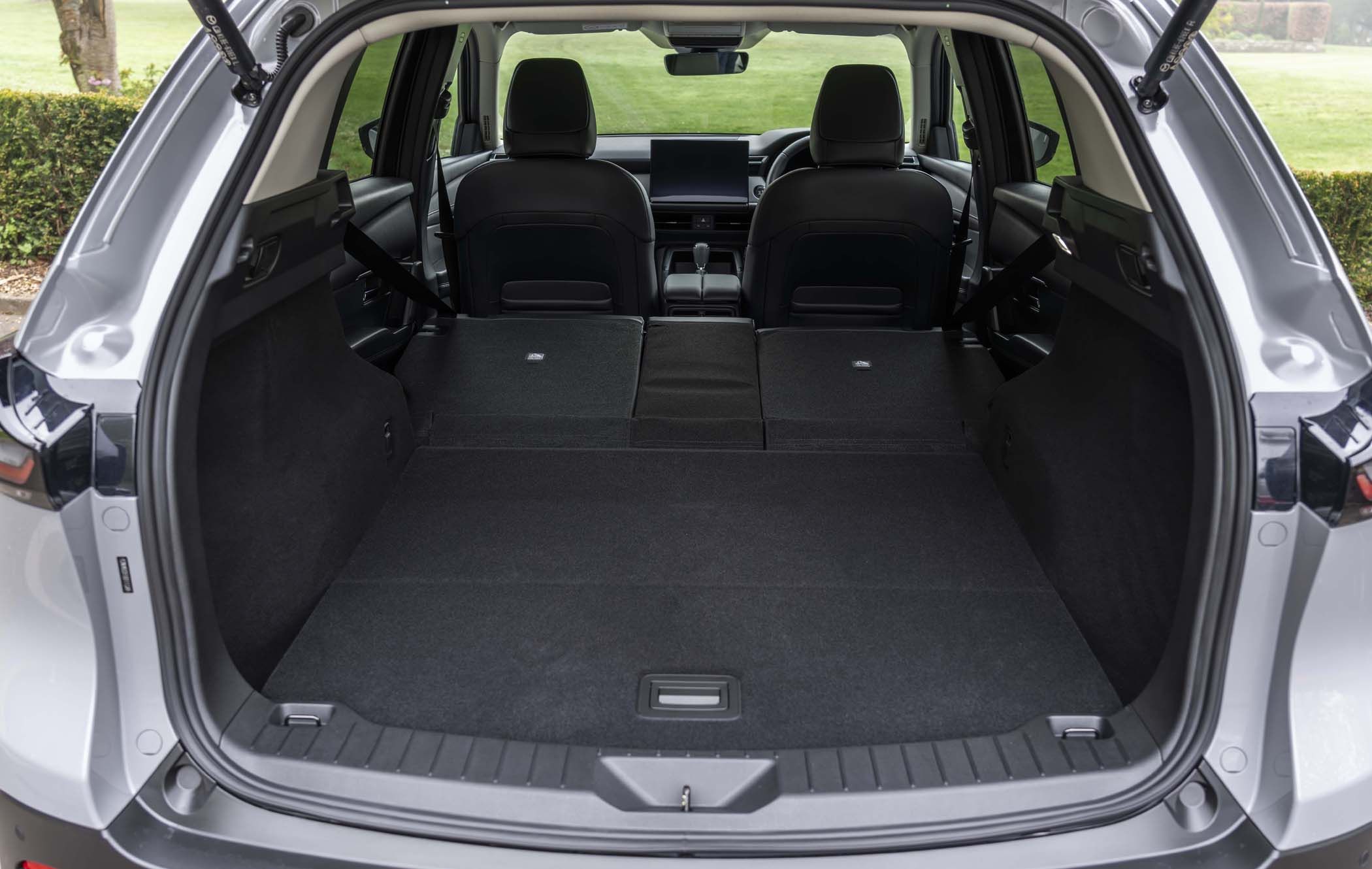 Open Mazda CX-5 boot showing spacious interior with rear seats folded flat, providing ample cargo space.