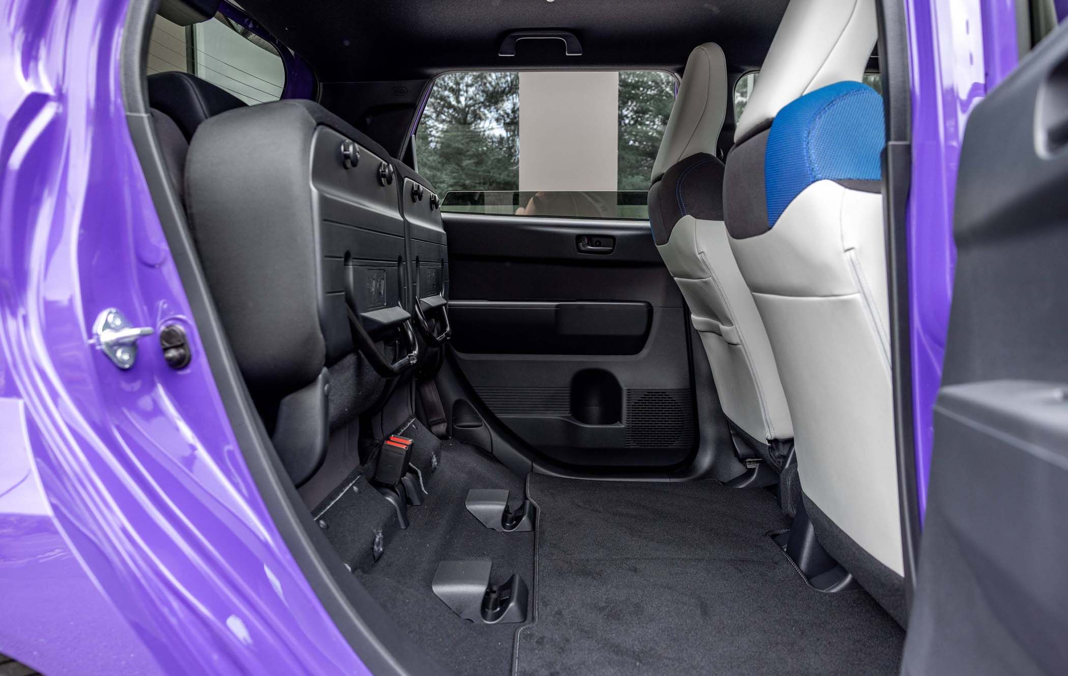 The interior of a Honda Super-N with rear seats folded down, showing spacious cargo area and front passenger seats upholstered in grey and blue.