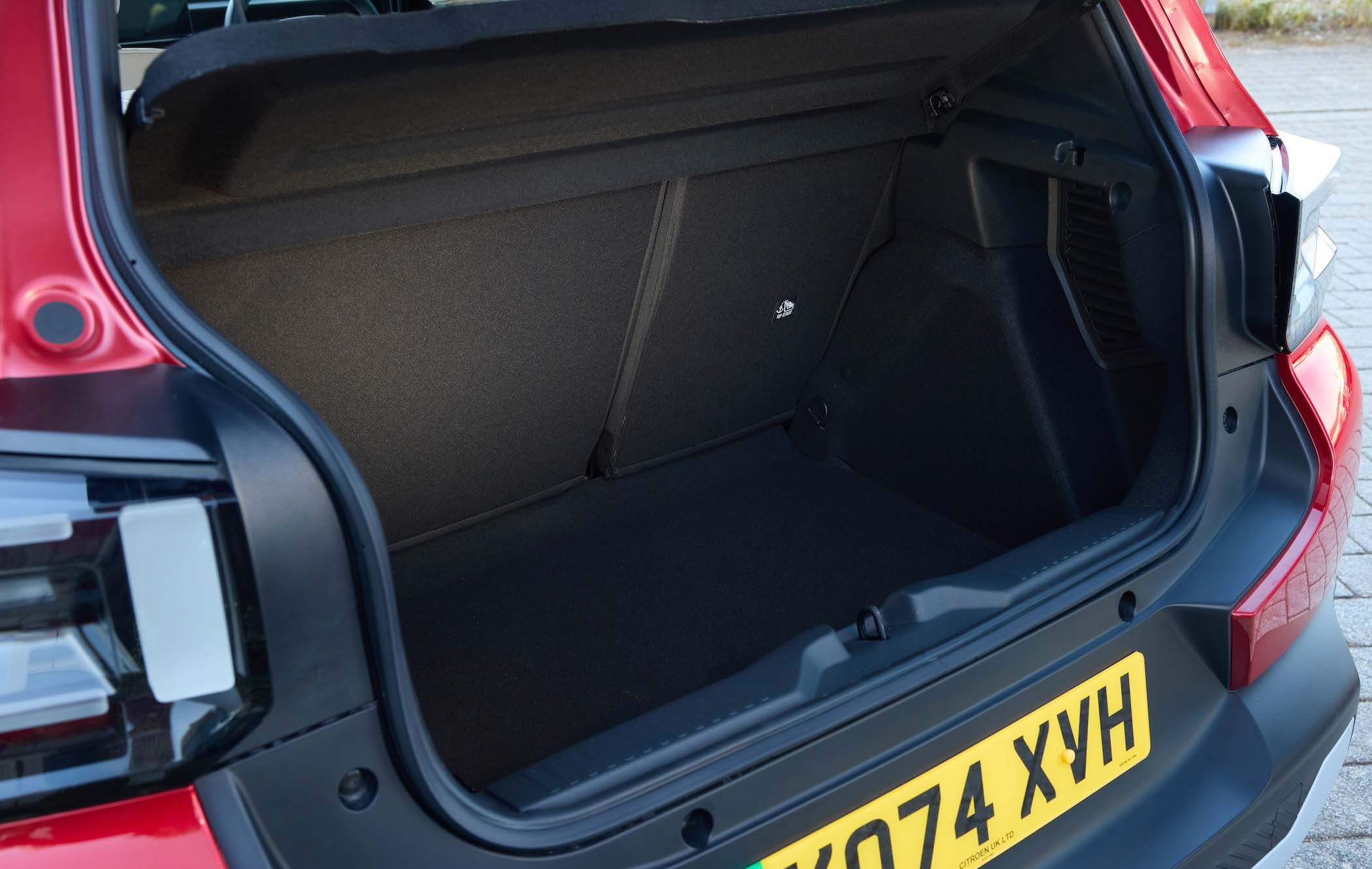 Open boot of Citroën ë-C3 with a spacious, empty cargo area and a visible UK license plate on the bumper.