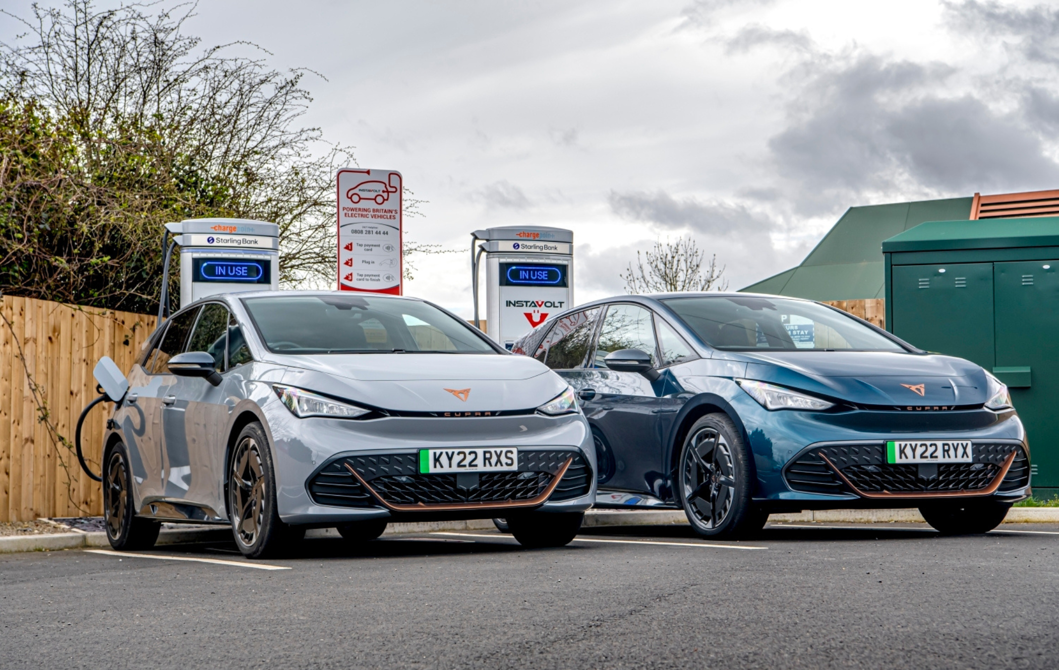 Two Cupra Born models parked using rapid chargers