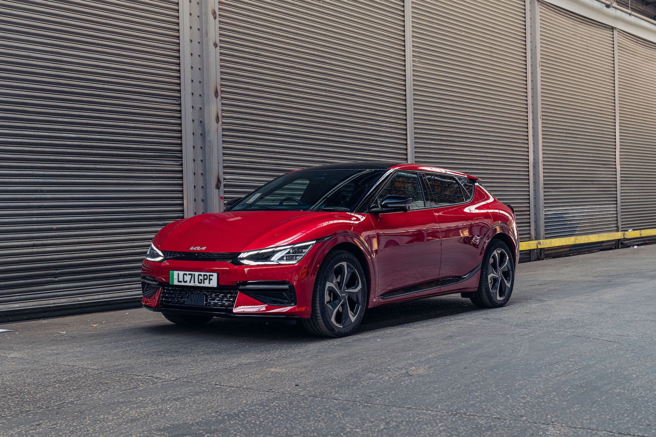 a dark red kia ev6 parked 