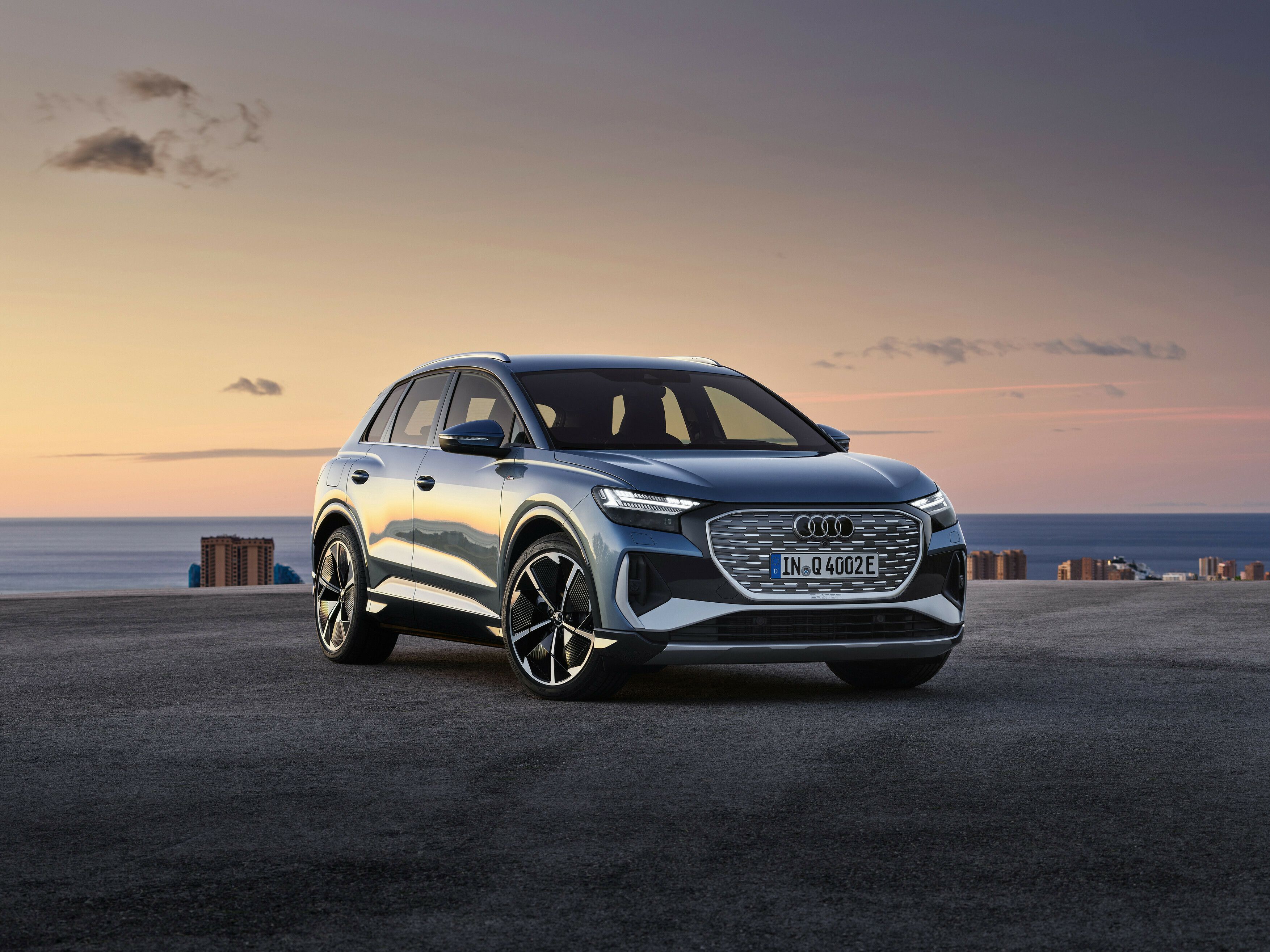 A grey Audi Q4 e-tron photographed from the side