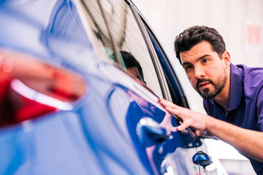 Mechanic checking bodywork at a cinch service centre