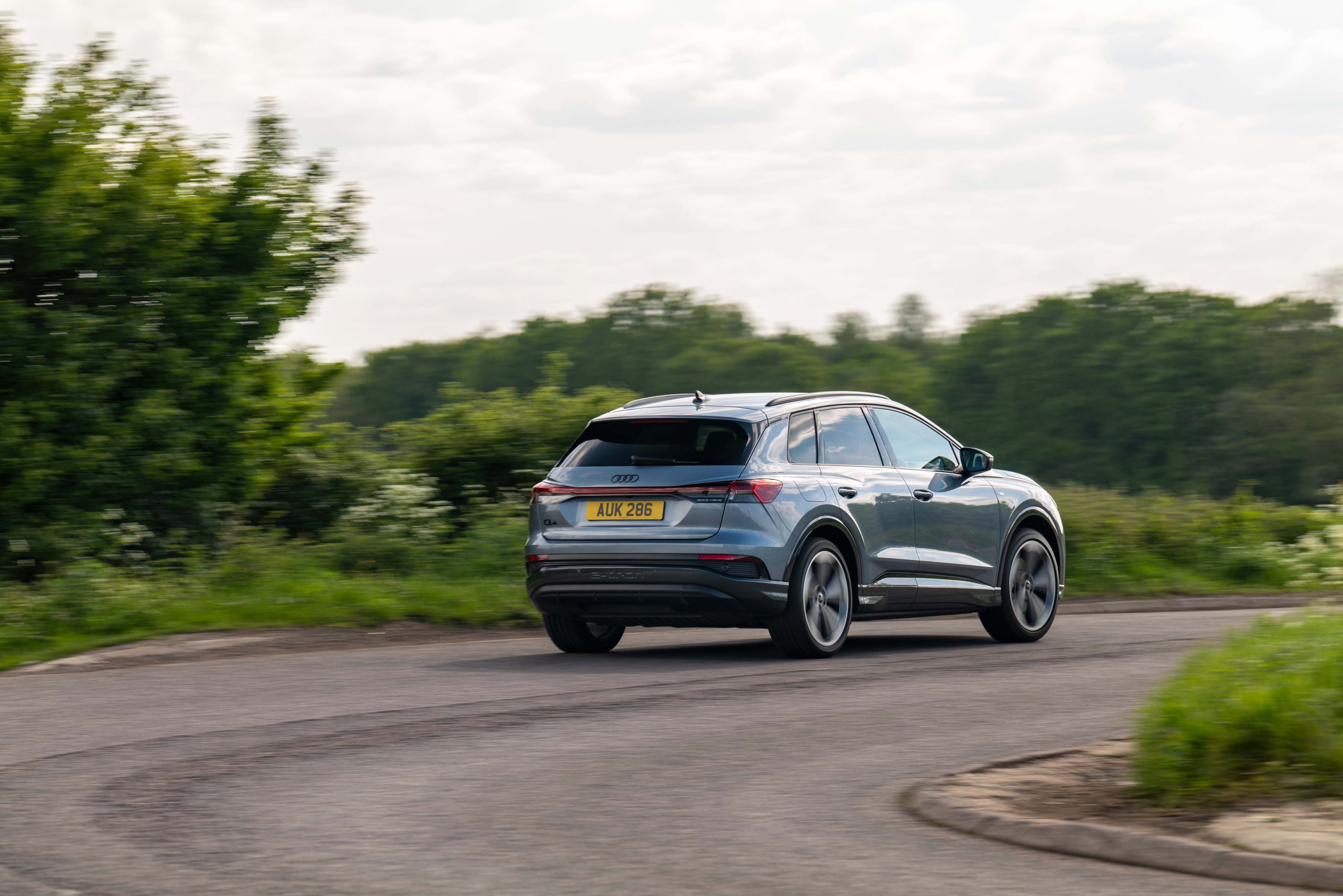 Audi Q4 e-tron rear three quarters, driving