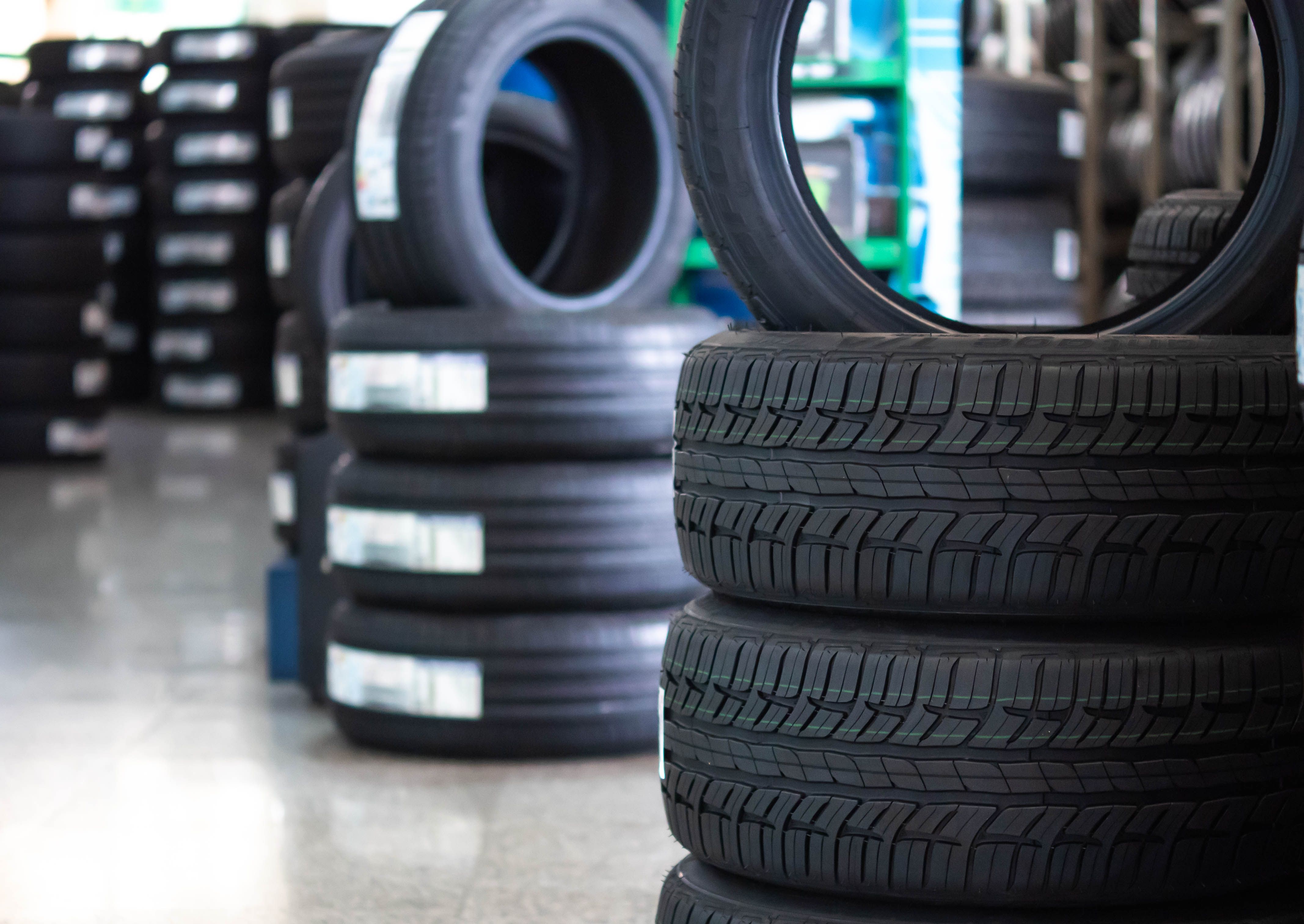 An image of stacked new tyres
