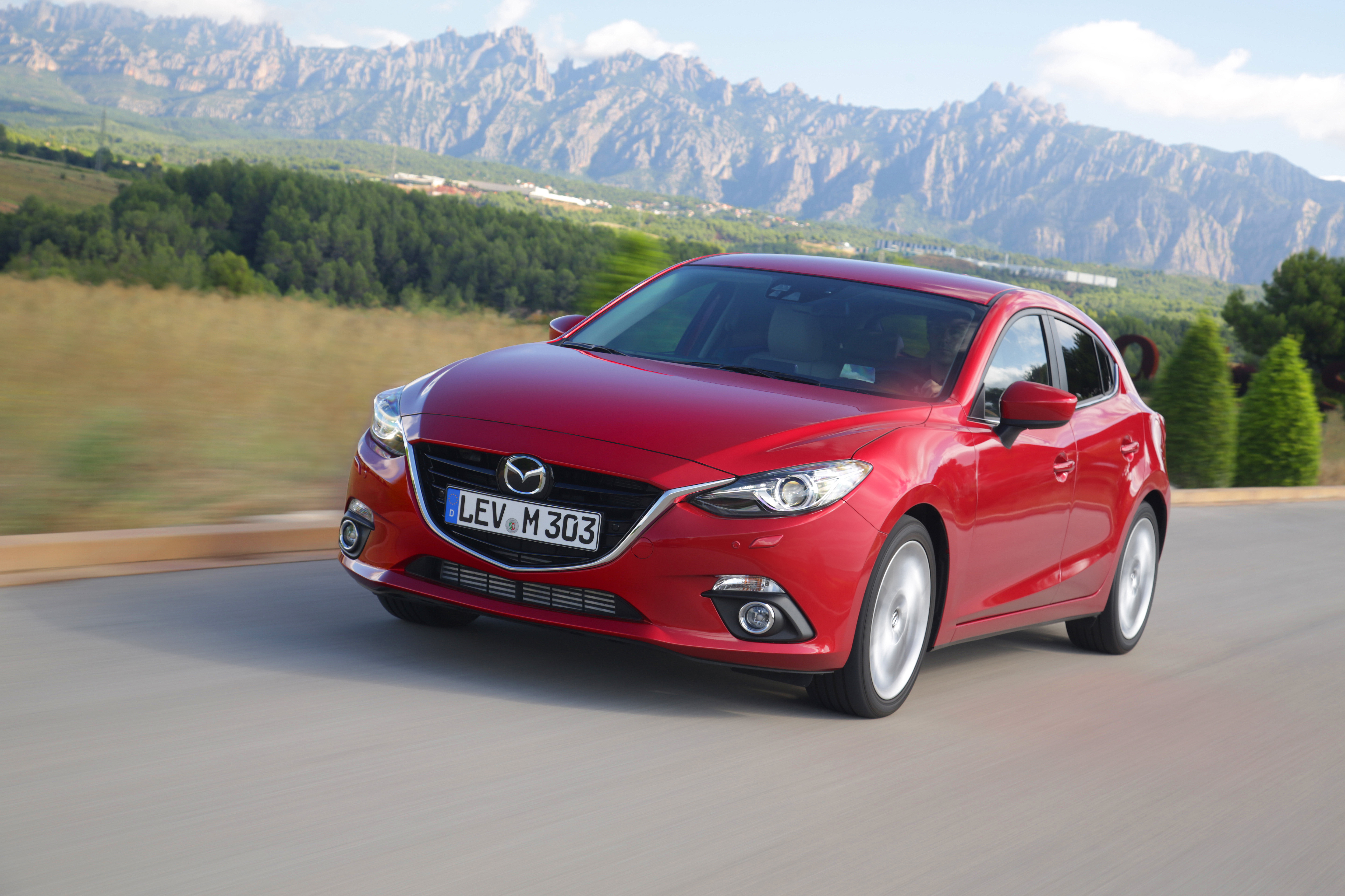 A red Mazda3 hatchback