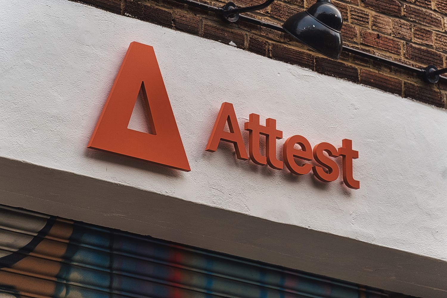 A replica of the Attest logomark and wordmark in the form of 3D acrylic, creating a warm welcome above their archway entrance in Shoreditch, London