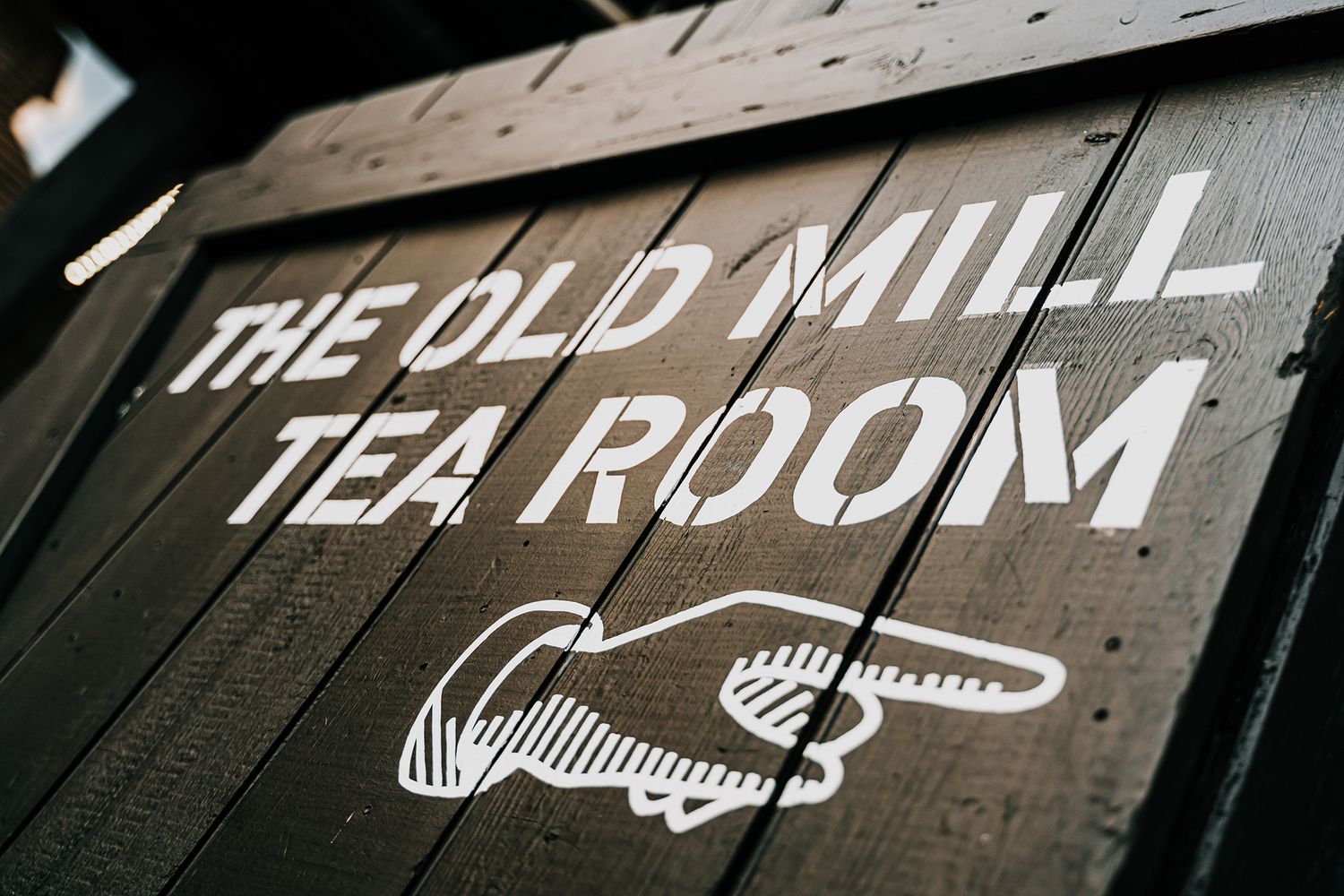 Tea room signage on black wood.