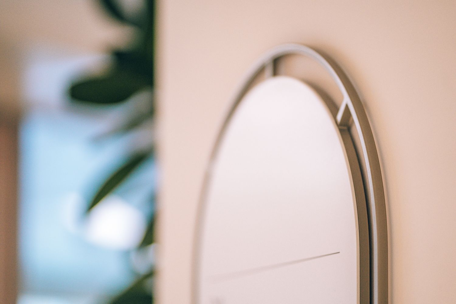 Close up of the curved metal frame used across the Ellisse Art Deco inspired workplace signage system.