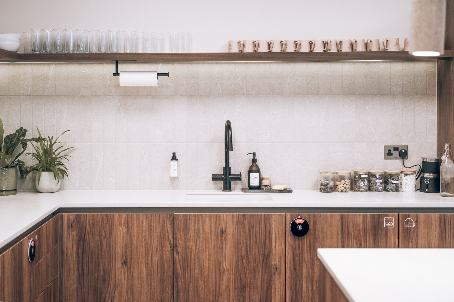 Branded kitchen and amenity signage at Ellisse, using minimal vinyl icons to identify shared workplace facilities.