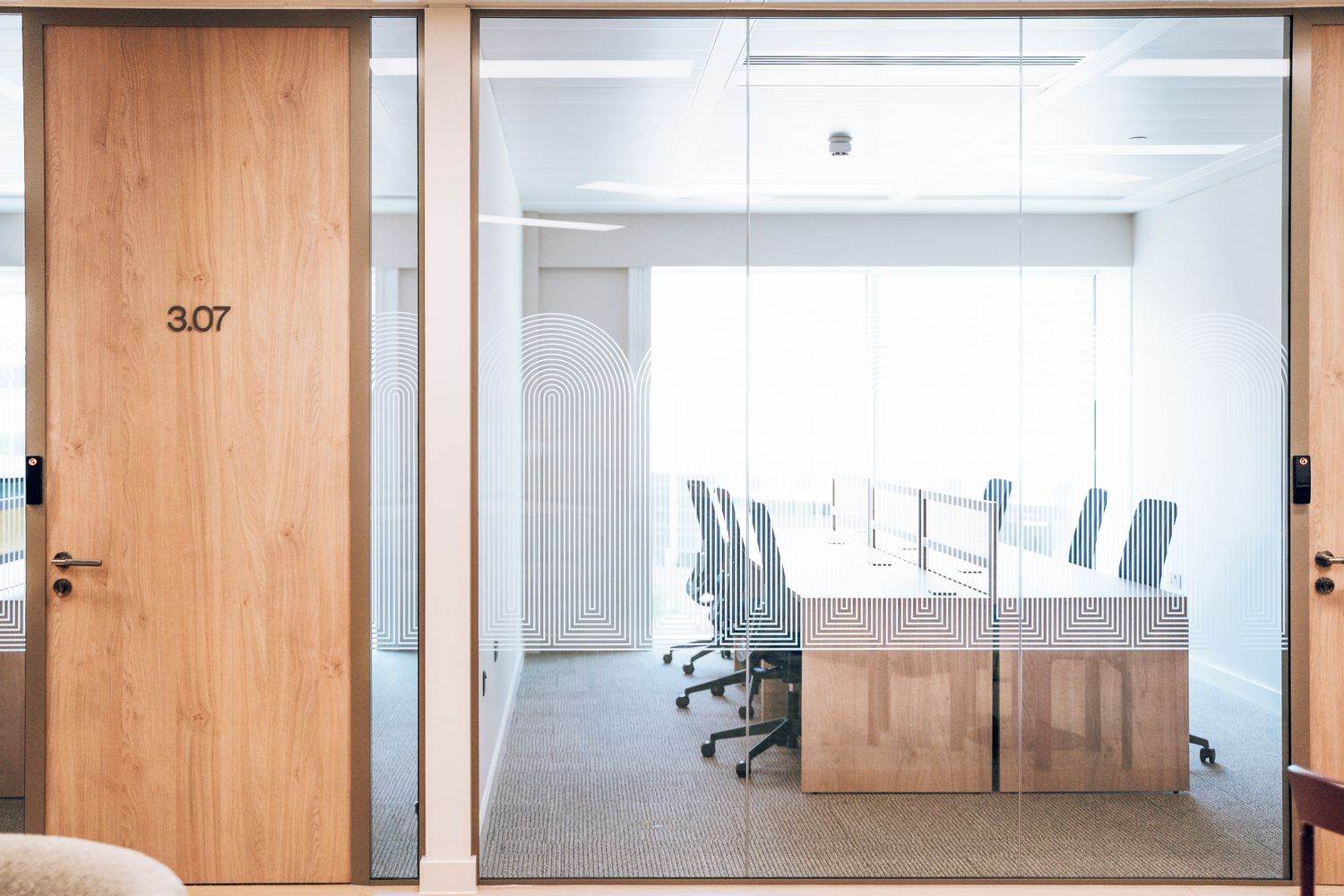 Ellisse meeting room with Art Deco inspired glass manifestation providing privacy across the glazed partition.