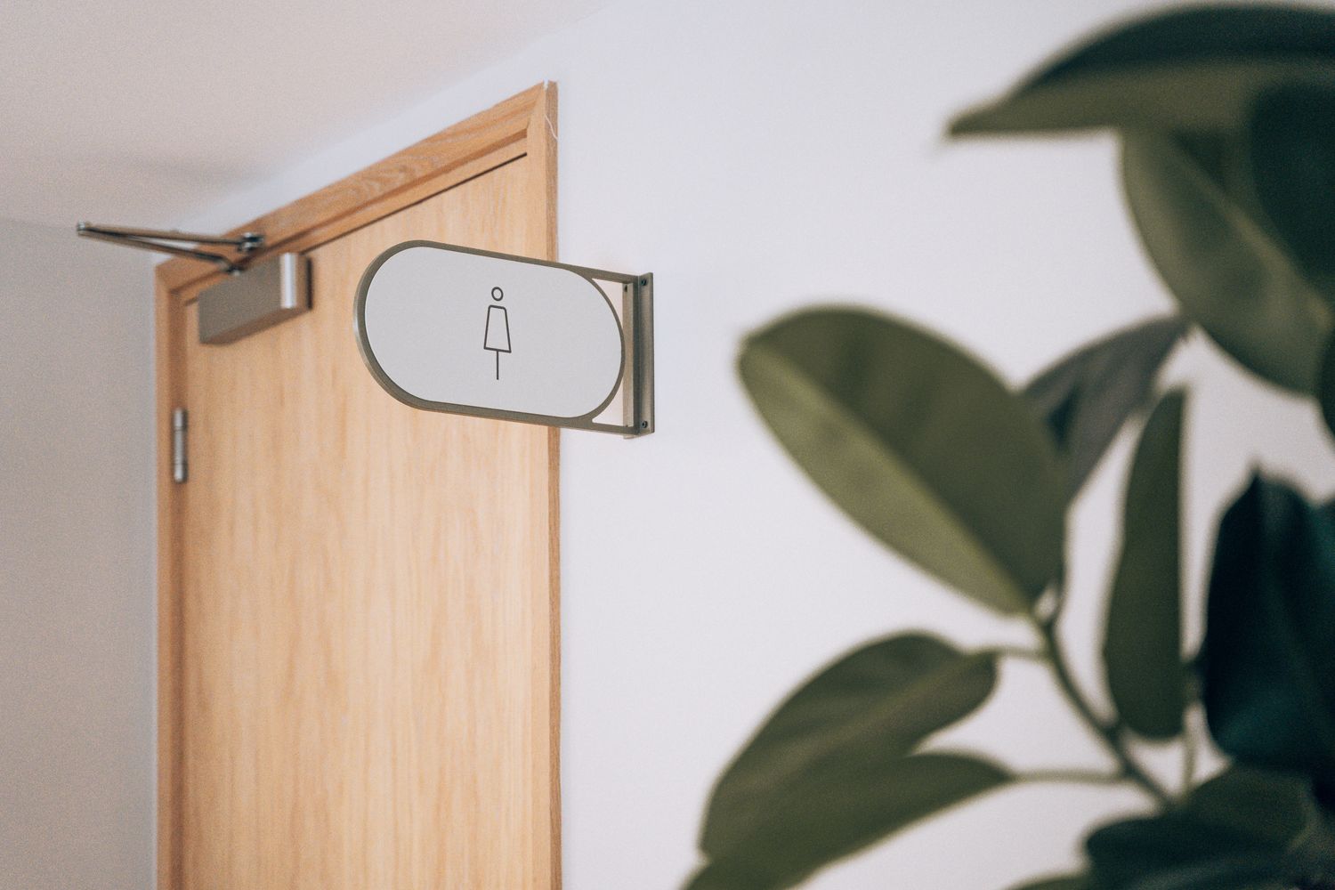 Double-sided projecting amenity sign at Ellisse by Spacemade, part of the bespoke workplace wayfinding system.