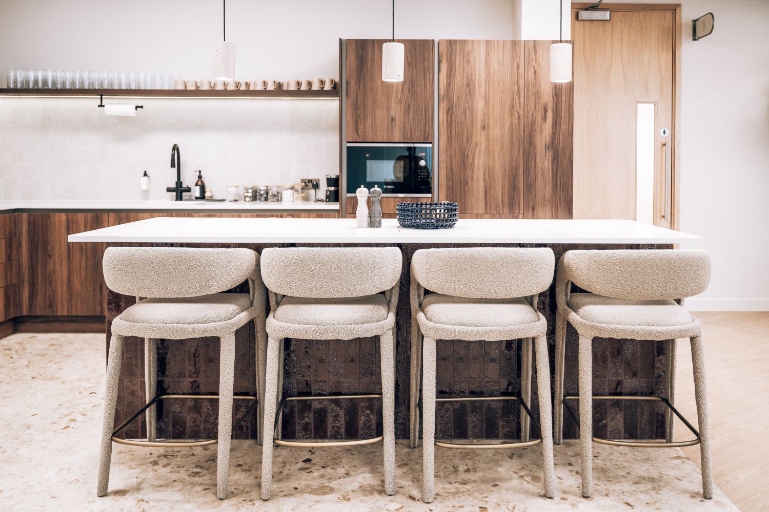 Ellisse co-working kitchen and breakout area with branded amenity signage integrated into the premium interior.