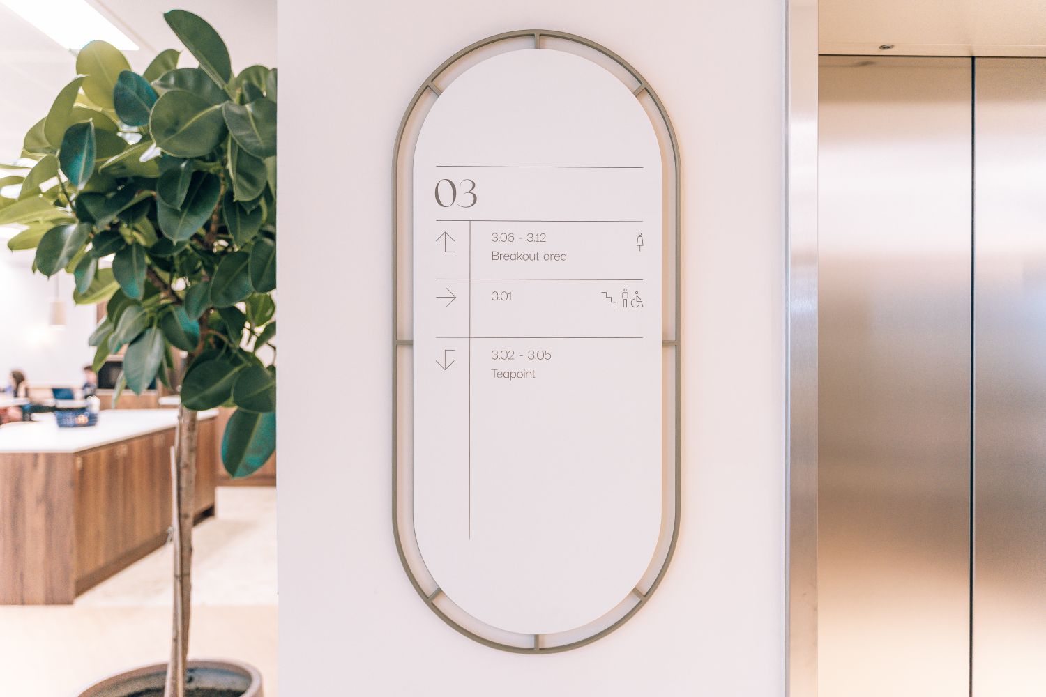 Floor level wayfinding directory at Ellisse by Spacemade, with bespoke metal framing integrated beside the lift lobby.