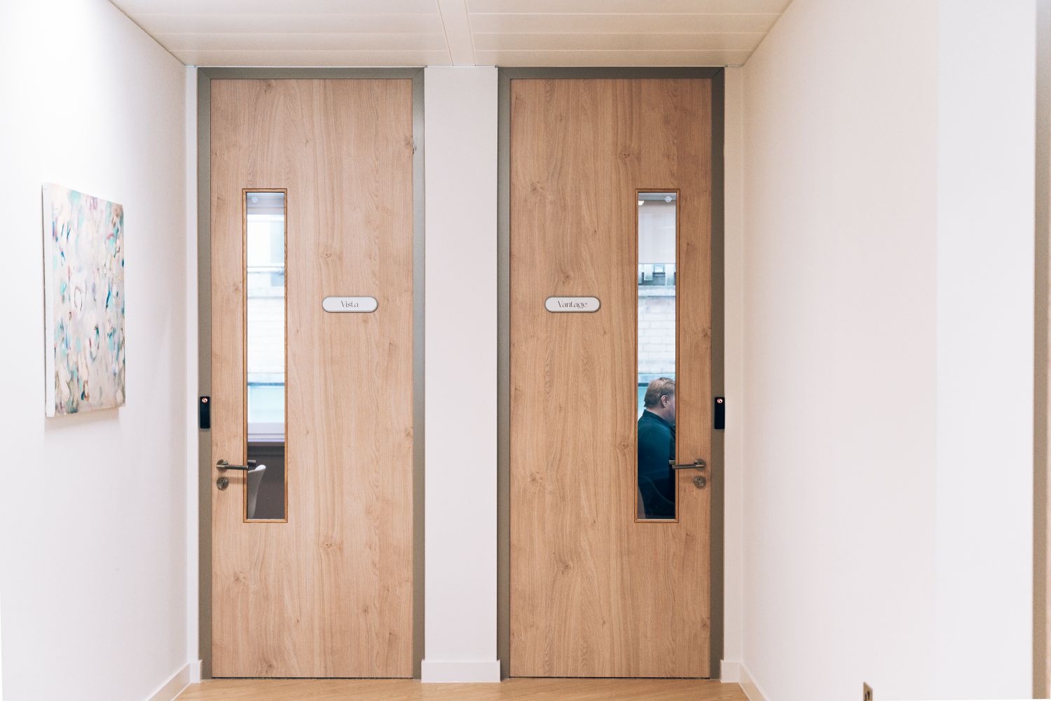 Meeting room entrance signage at Ellisse by Spacemade, integrated into the timber doors and office interior.