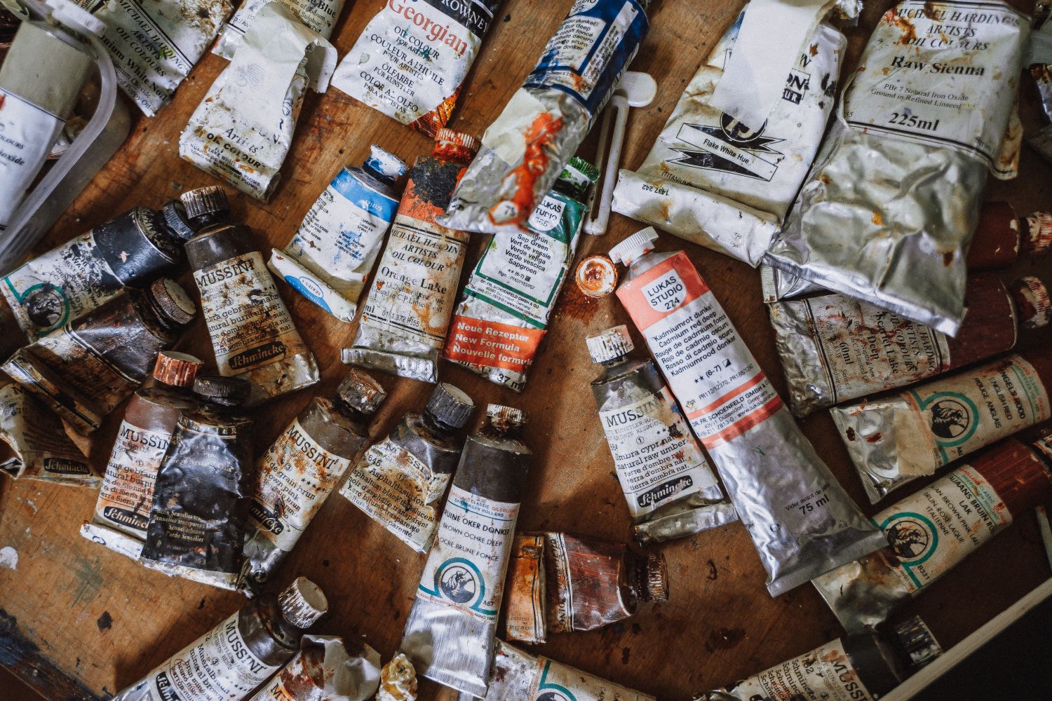 Oil paint tubes and materials used by portrait painter John Burke during his painting process