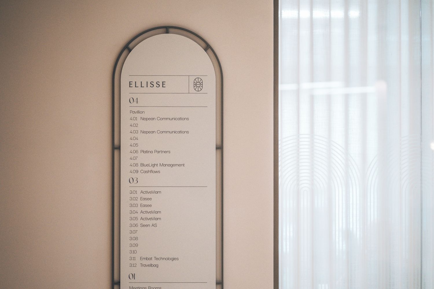 Bespoke 3D office directory at Ellisse by Spacemade, with curved metal frame and branded wayfinding beside frosted glass with matching window manifestation.