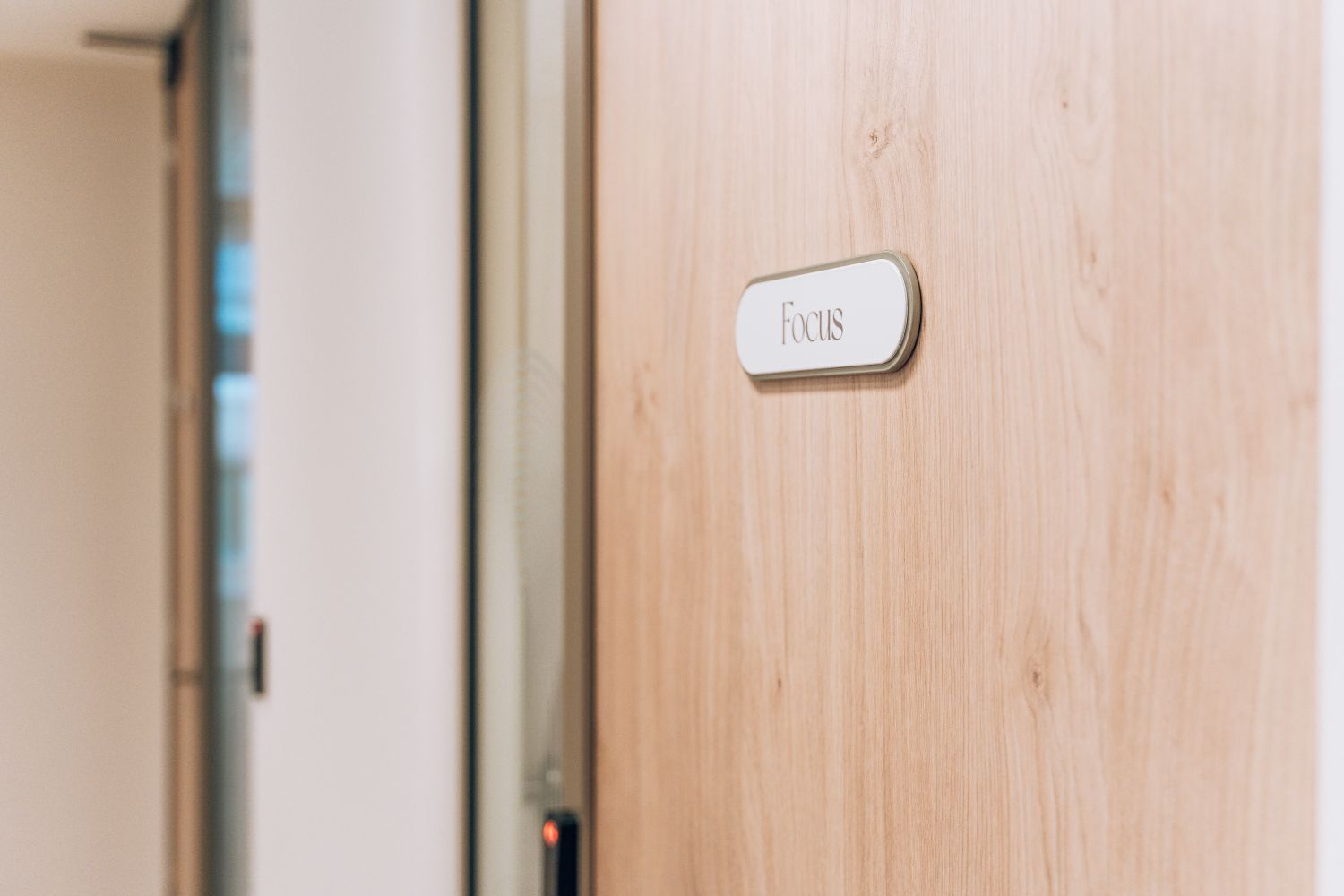 Focus meeting room name plaque at Ellisse by Spacemade, integrated into the timber office door.