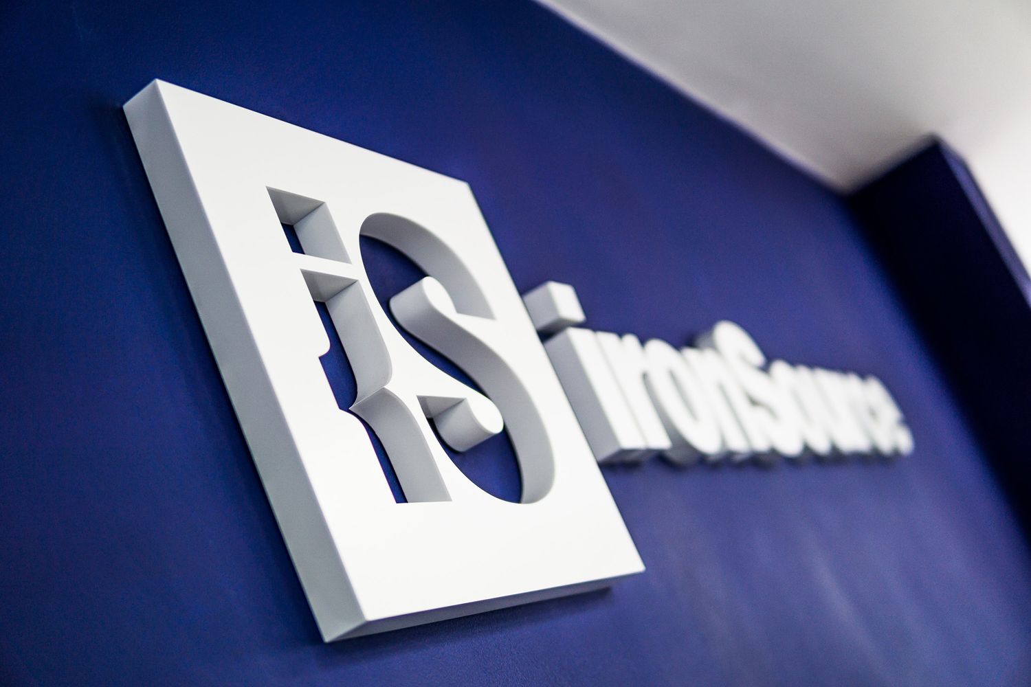 Reception 3D letters displaying the company logo and company name in large white build up letters fixed on a royal blue wall