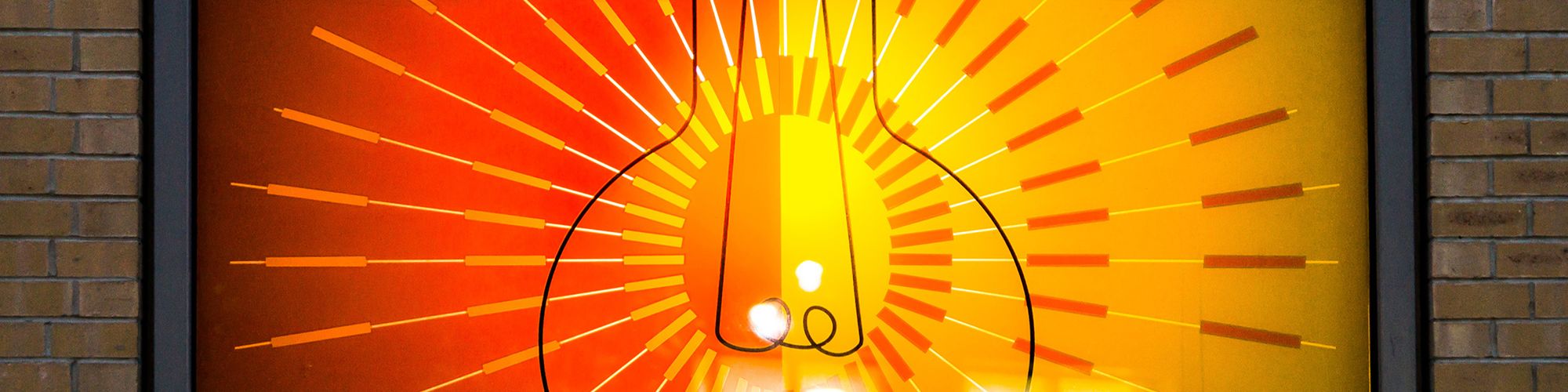 Window with bright and colourful cut vinyl design of a light bulb
