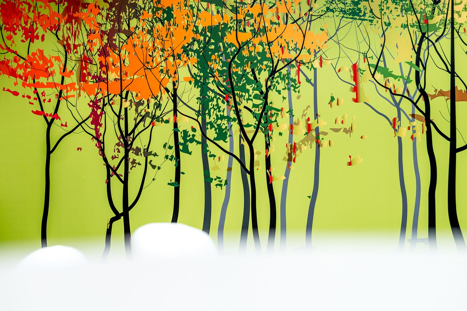 Vinyl wallpaper of autumn trees on a lime green background.