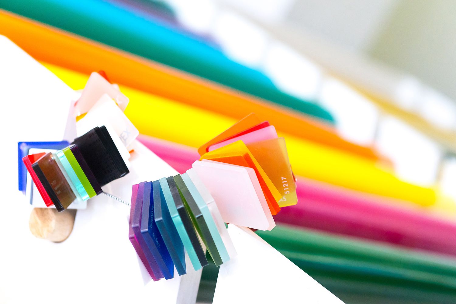 a colourful picture of acrylic samples on the side of vinyl rolls