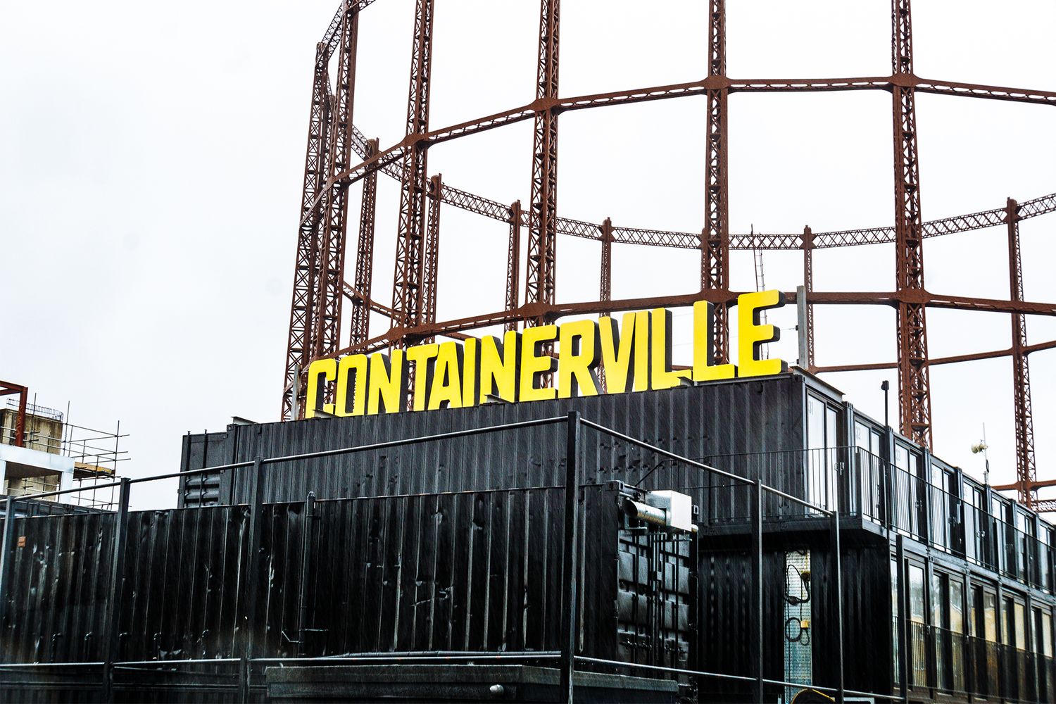 Large yellow 3D outdoor letters appearing on top of the containers.