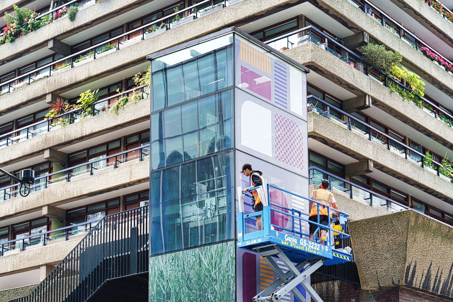 Our guys at Glyphics utilising the scissor lift to scale greater heights, installing a fresh new facade for the Moor Lane elevators.