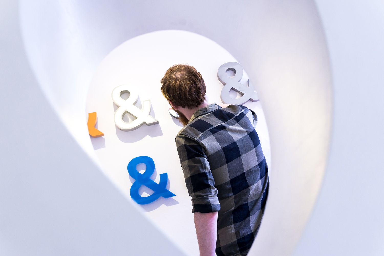 Wall of ampersand signs through a giant wooden sign