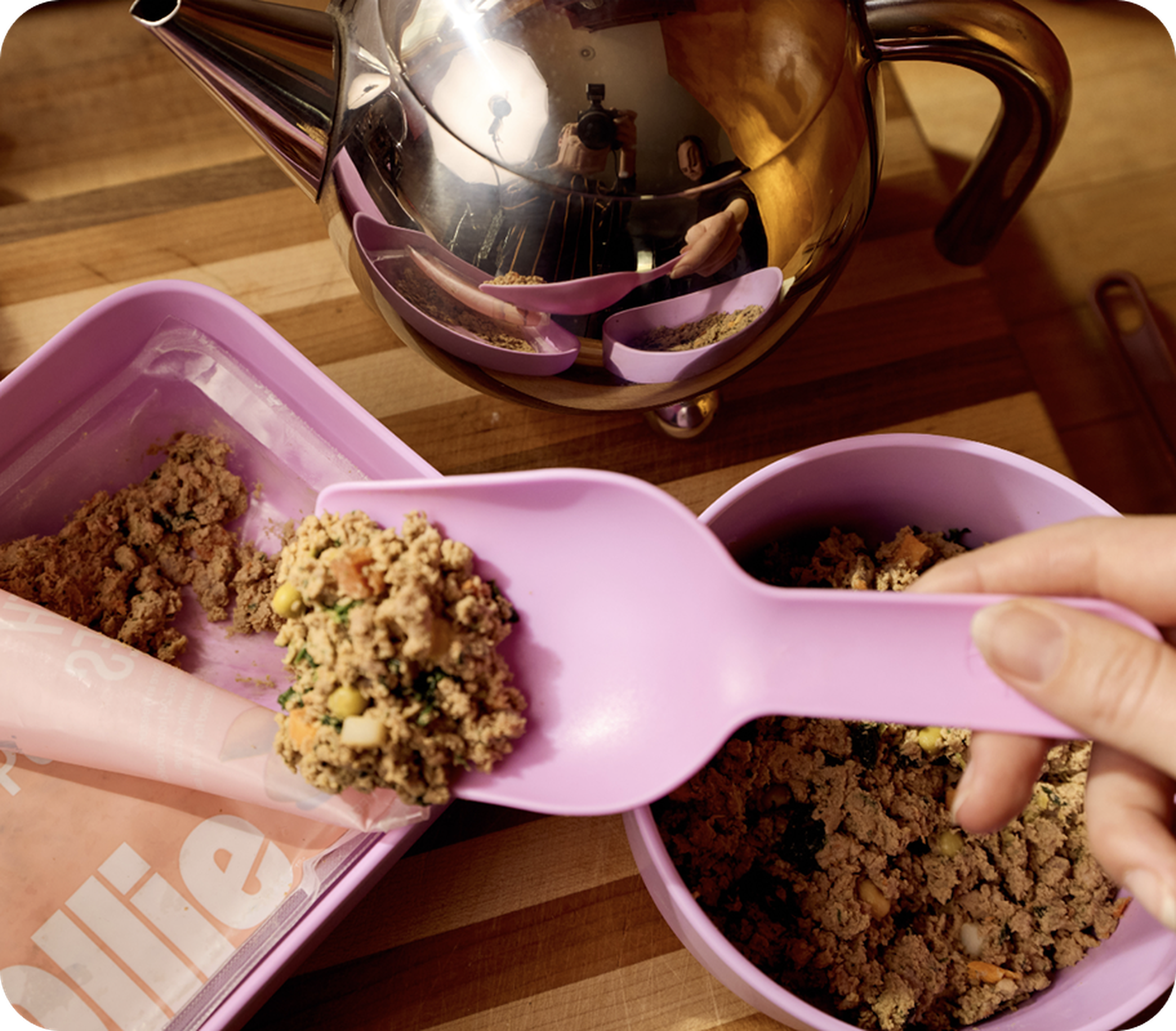 Fresh food being scooped out next to a tea kettle