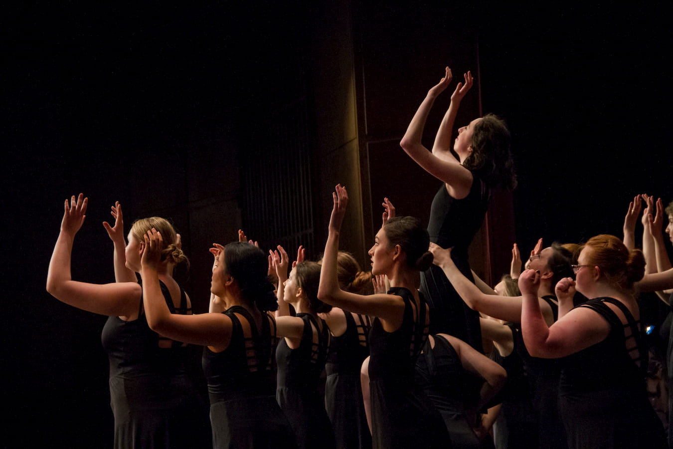Contemporary dancers in an expressive group pose