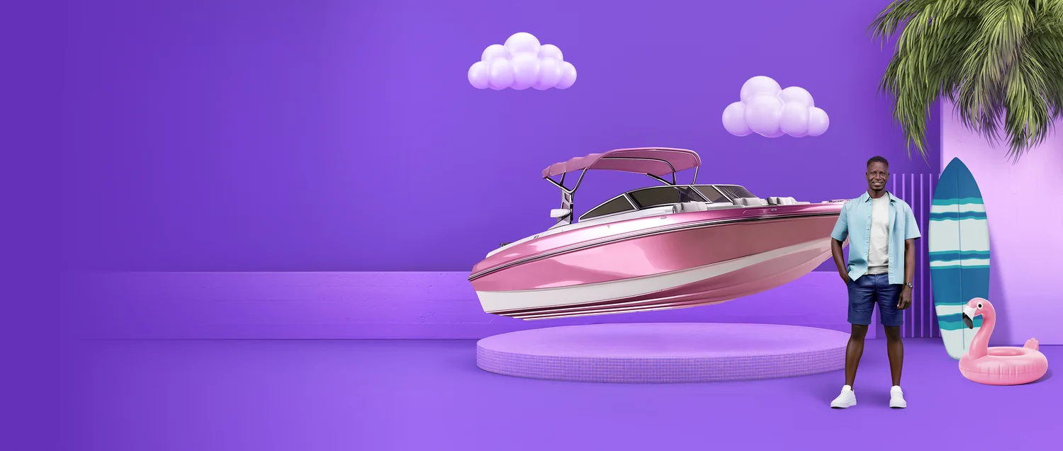 Man standing next to a speedboat surrounded by clouds, a surfboard and inflatable flamingo