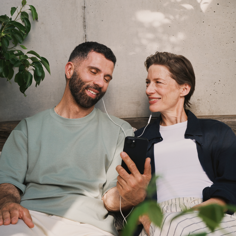 Two people listening to audio from the phone
