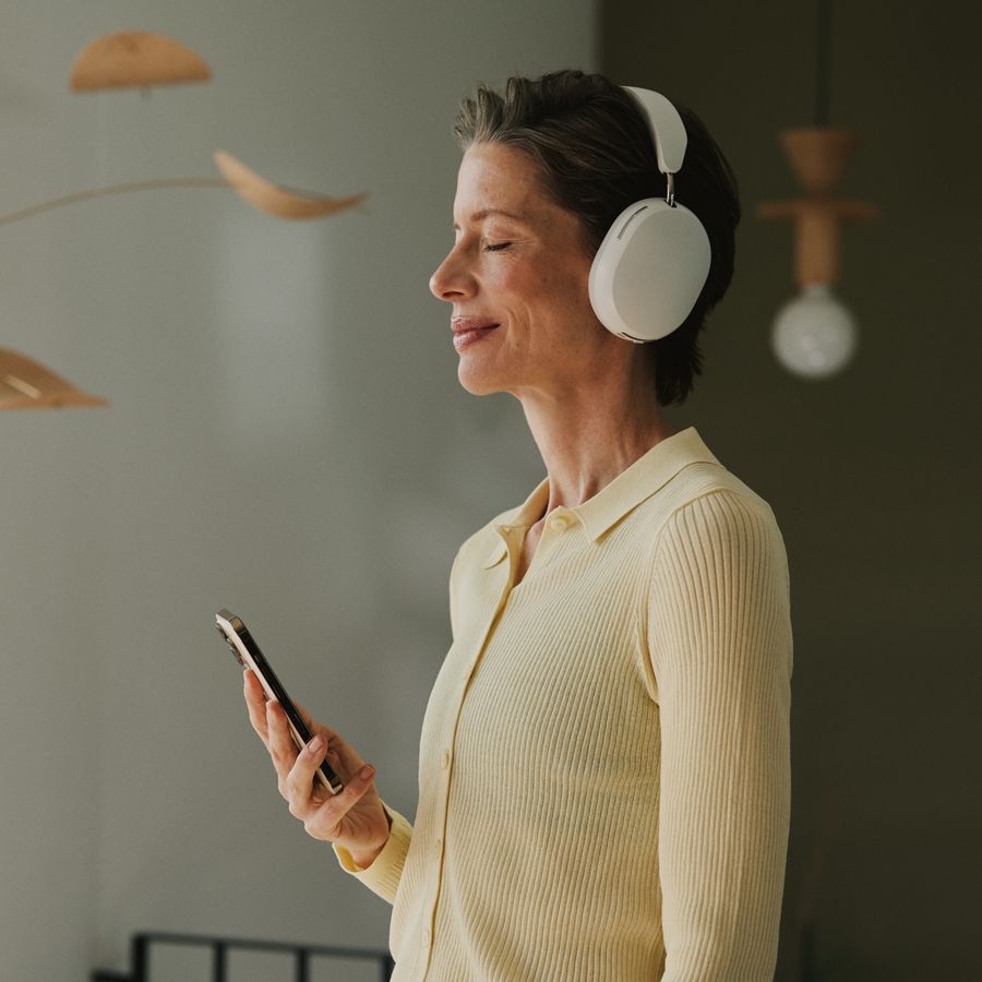 Woman with headphones from the side, eyes closed