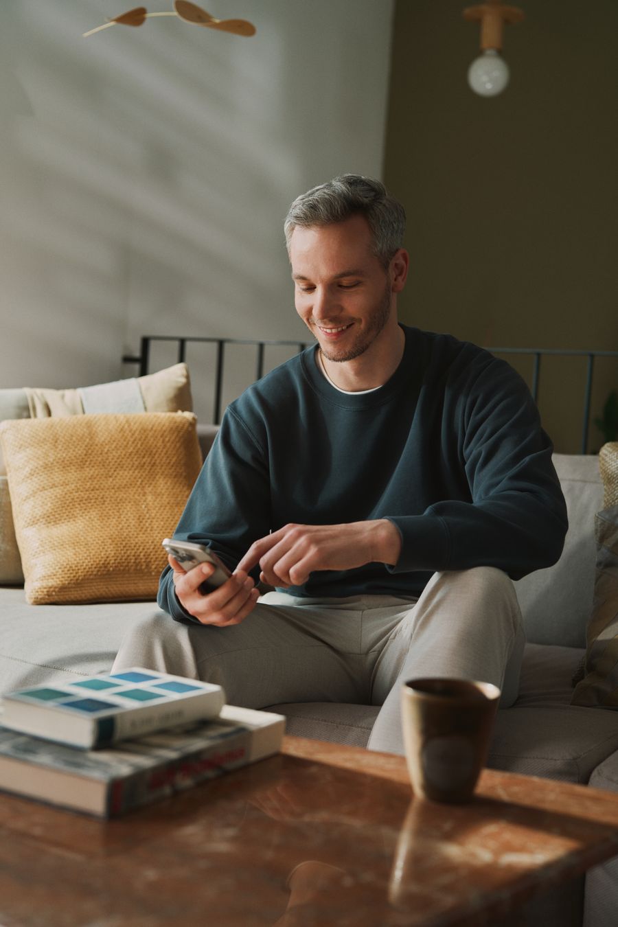 man looking at his phone and smiling
