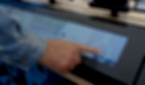A person pointing to an Amazon Echo device on an interactive screen