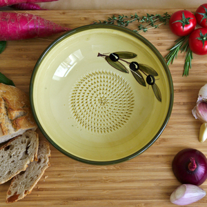 a handmade ceramic plate with olive oil painting