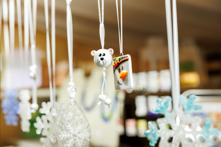 Hanging decorations include a polar bear and snowman amidst snowflakes. The festive ornaments create a cheerful, whimsical winter atmosphere.