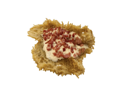 Crispy fried cheese topped with creamy sauce and diced cured meat, isolated on a white background.