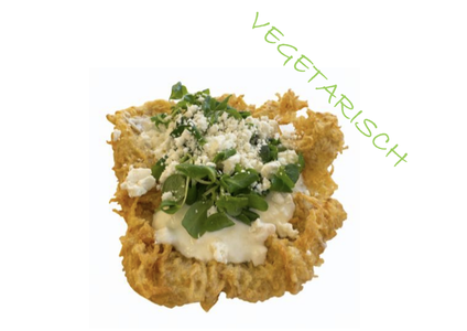 Crispy vegetarian fritter topped with sour cream, fresh greens, and crumbled cheese. The word "VEGETARISCH" is written diagonally.