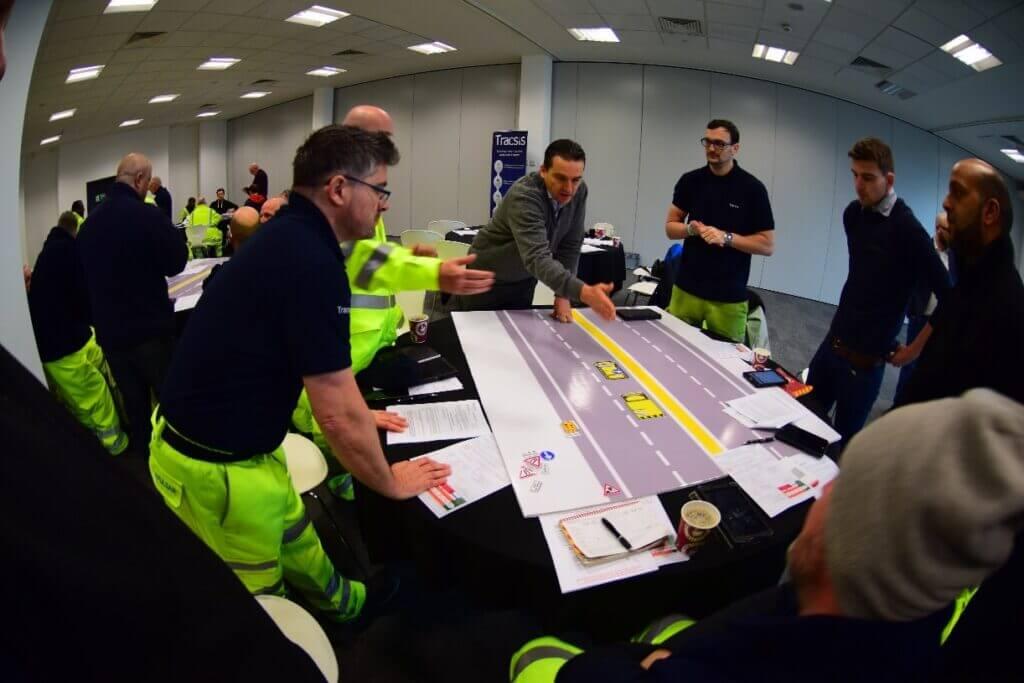A team modelling cars on a road.
