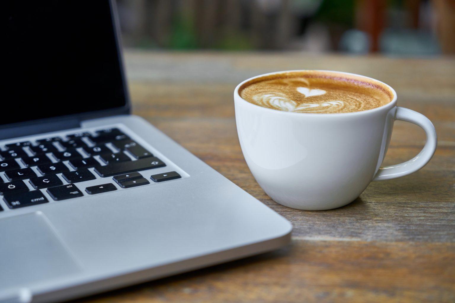 A cup of coffee and a notebook PC